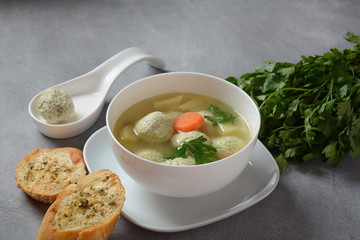 Low fat vegetable soup with chicken meatballs, potato and carrot and fresh herbs in bowl, Healthy food diet