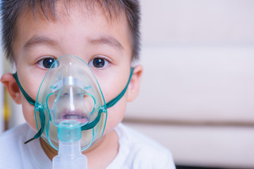 Close up asian little boy inhaler he use making inhalation nebulizer