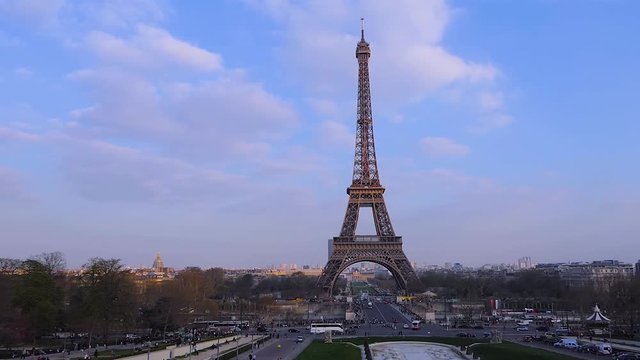 Eiffel Tower in Paris city with fast flying bird on cloudy morning skies. Royalty free Full HD stock footage for your projects related to France, French and European life, travel, culture, business.