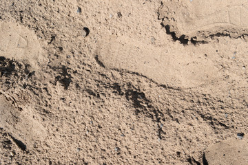 Human footprints on the sand. Sand texture, background. Grunge sand background.