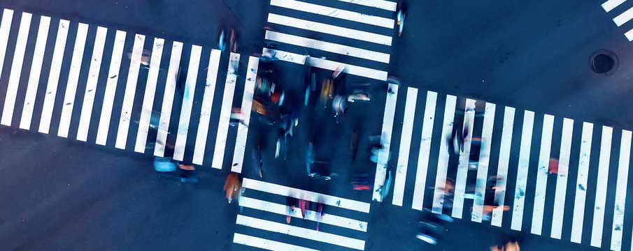 Aerial view of people crossing a big intersection in Ginza, Tokyo, Japan at night