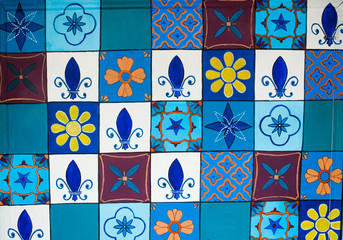 Set of colorful small tiles on a wall of a building. Traditional Mexican art
