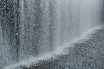 Close up wall with falling water in a dam