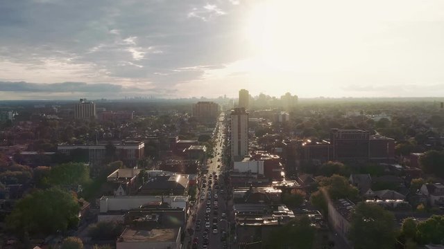 Aerial establishing shot of a generic residential area in a large city at dusk. Cinematic 4K footage.
