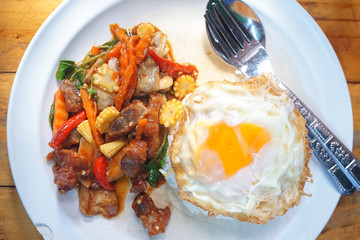 Stir fried Crispy pork with chili and holy basil eat with steamed rice and  fried egg