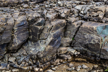 Close-up relief of big rocks. Natural igneous rock background texture