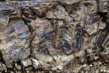 Close-up relief of big rocks. Natural igneous rock background texture