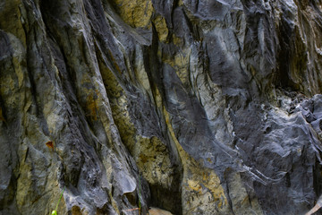 Close-up relief of big rocks. Natural igneous rock background texture