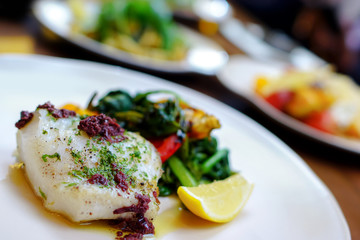 Snow fish fillet steak with black olive - Italian restaurant