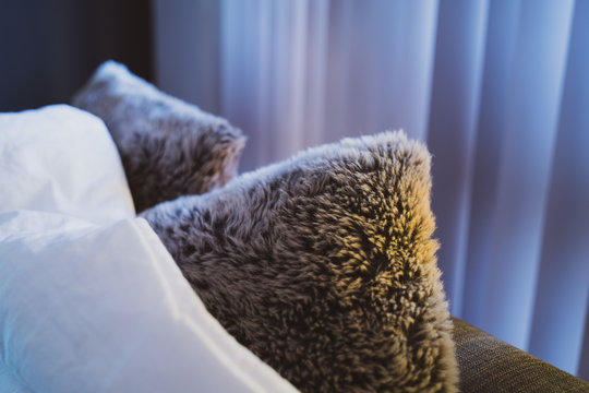 Furry pillow  and blanket on counch