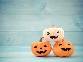 Orange and white pumpkins halloween decorate on blue wooden background. Use for halloween concept.
