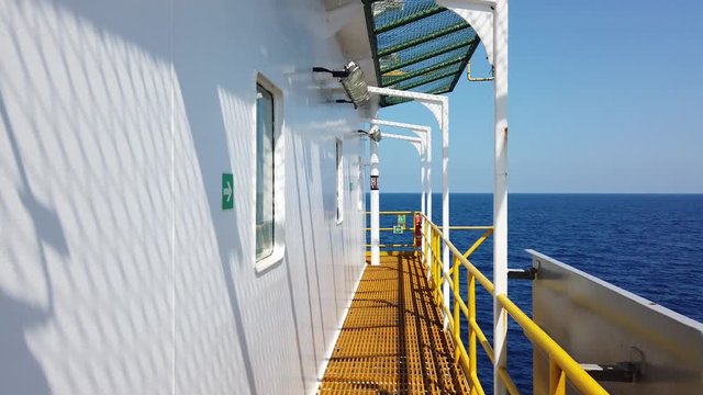 Walking on the grating beside an accommodation of a tender drilling rig