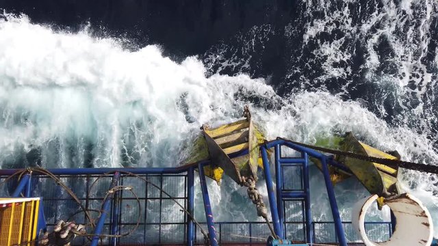 The anchor of tender assisted drilling oil rig (Barge Oil Rig) stored at the cow catcher during the rig move with wave hitting the anchor.