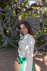 girl at the fence in the summer park