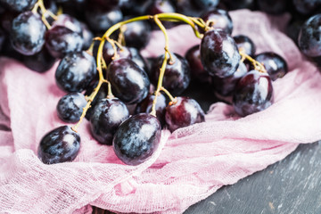 Ripe black grape on the rustic background. Selective focus. Shallow depth of field.