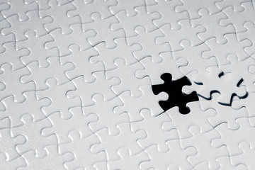 Close up piece of white jigsaw puzzle