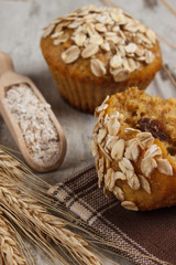 Fresh muffins with oatmeal, rye flour and ears of rye grain, delicious healthy dessert