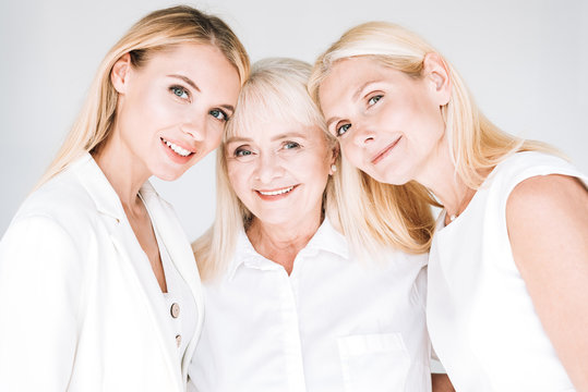 three generation blonde beautiful women isolated on grey