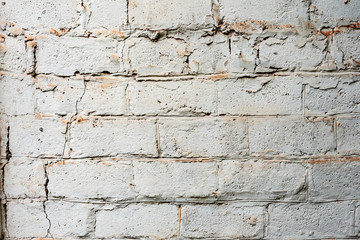 Texture of a brick wall with cracks and scratches which can be used as a background