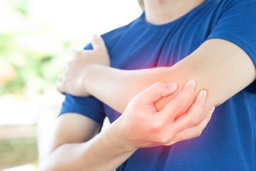 Picture of a man holding his hand to the elbow