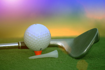 Golf ball and golf club in the evening golf course with sunshine in thailand