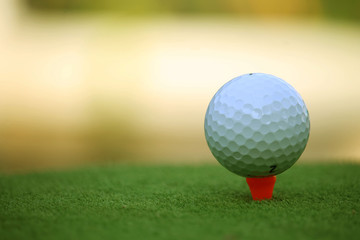 Golf ball on tee in the evening golf course with sunshine in thailand