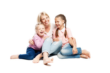 Mom and daughters are sitting and laughing. Love and tenderness. Isolated over white background.