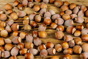 Heap of hazelnuts on a wooden table