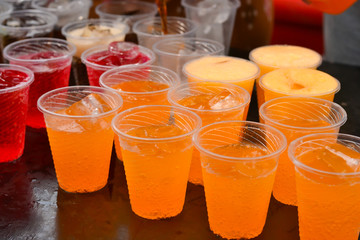 Colorful soft drink in plastic cup