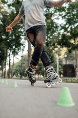 Fototapeta premium Roller skating, skater rolling around the cones
