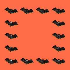 オレンジバックにコウモリを並べて真ん中にコピースペース