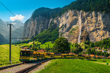 Electric tourist train and Lauterbrunnen village in background, Switzerland