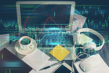 Double exposure of graph and financial info and work space with computer background. Concept of international online trading.