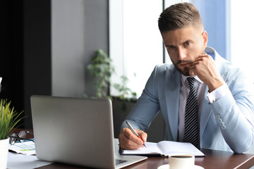 Modern businessman thinking about something while sitting in the office