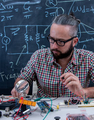 Tech postgraduate student working on electronic project