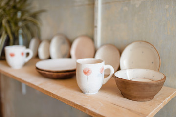 Fototapeta na wymiar Kitchen utensils on shelf in pottery workshop