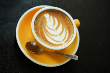 Coffee Latte leaf pattern face on black table