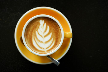 Coffee Latte leaf pattern face on black table
