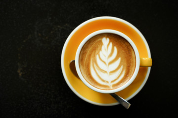 Coffee Latte leaf pattern face on black table