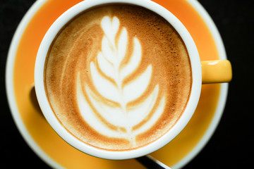 Coffee Latte leaf pattern face on black table