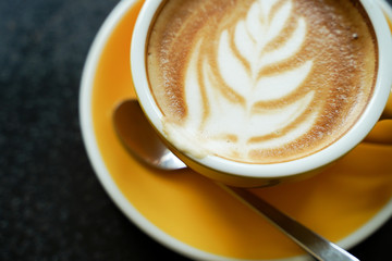 Coffee Latte leaf pattern face on black table