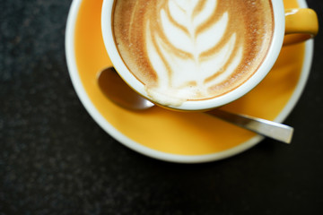 Coffee Latte leaf pattern face on black table