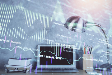 Double exposure of graph and financial info and work space with computer background. Concept of...