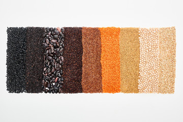 top view of assorted black beans, rice, quinoa, buckwheat, chickpea and red lentil isolated on white