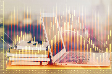 Obraz premium Financial market graph hologram and personal computer on background. Double exposure. Concept of forex.