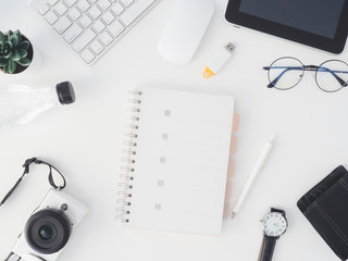 top view of office desk table with notebook, plastic plant, digital camera and keyboard on white background, graphic designer, Creative Designer concept.