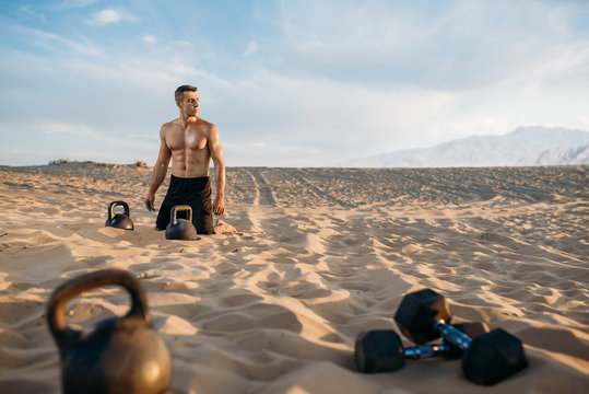 Male athlete after workout in desert at sunny day