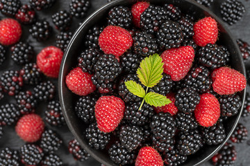 Background from fresh organic blackberries and raspberries, close up. Top view blackberry and raspberry