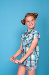 Half length portrait of a little funny naughty girl   against  blue background