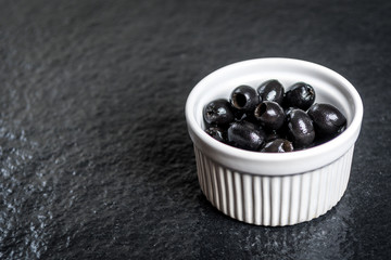Black olives on black stone